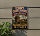 A vintage-style metal sign for the Fort Creve Coeur State Historic Site in Illinois, featuring an illustration of a historic building and a banner that reads "Discover Illinois History".