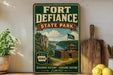 a vintage-style sign for Fort Defiance State Park, with a scenic illustration of the park and its surroundings.