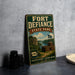 A vintage-style metal sign for Fort Defiance State Park, featuring a scenic image of the park and its surroundings.