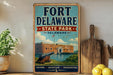 A vintage-style metal sign for Fort Delaware State Park in Delaware, featuring an illustration of the fort and surrounding landscape.