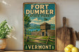 A vintage-style sign for Fort Dumber State Park in Vermont, featuring a wooden fort and a scenic landscape.