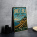 A vintage-style metal sign for Fort Ebey State Park in Washington, featuring a scenic landscape with a cliff, grassy area, and a body of water.