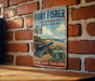 A vintage-style metal sign for Fort Fisher, a state recreation area in North Carolina, featuring a cannon and a beach scene.