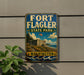 A vintage-style sign for Fort Flagler State Park in Washington, featuring a castle, trees, and a body of water.