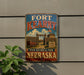 A vintage-style metal sign for Fort Kearny, Nebraska, featuring an illustration of the fort and surrounding landscape.