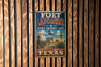 A vintage-style metal sign for the Fort Lancaster State Historic Site in Texas, featuring an illustration of a wagon and a building.