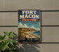 A vintage-style metal sign for Fort Macon State Park in North Carolina, featuring a coastal scene with a brick fort and a beach.