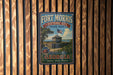 A vintage-style metal sign for Fort Morris Historic Site in Georgia, featuring a wooden fence and a building with an American flag.