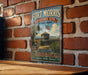A vintage-style metal sign for Fort Morris Historic Site in Georgia, featuring an illustration of a fort and palm trees, mounted on a brick wall.