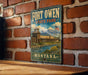 A vintage-style metal sign for Fort Owen State Park in Montana, featuring a scenic illustration of the park's landscape and buildings.