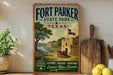 A vintage-style sign for Fort Parker State Park in Texas, featuring a scenic landscape with a castle, trees, and a river.