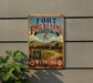 A vintage-style metal sign for Fort Phil Kearny, a historic site in Wyoming, with a desert landscape and a flagpole in the background.