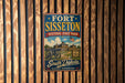 A vintage metal sign for Fort Sisset, Historic State Park in South Dakota, featuring an illustration of a cannon and a building.
