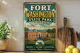 A vintage-style metal sign for Fort Washington State Park in Maryland, featuring an illustration of the fort and surrounding landscape.