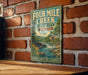 A vintage-style metal sign for Four Mile Creek State Park in New York, featuring a scenic illustration of the park's natural landscape.