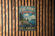 A vintage metal sign for Fox Point State Park in Delaware, featuring a lighthouse and a scenic landscape.