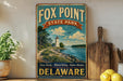 a vintage-style sign for Fox Point State Park in Delaware, with a lighthouse and a scenic landscape in the background.