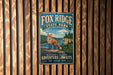A vintage metal sign for Fox Ridge State Park in Illinois, featuring an illustration of a fox in a forest setting.