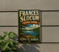 A vintage-style metal sign for Frances Slocum State Park in Pennsylvania, featuring a scenic landscape with a lake, trees, and a sailboat.