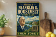 a vintage-style metal sign with a portrait of Franklin D. Roosevelt, the former US President, and text welcoming visitors to the State Park in New York.