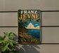 A vintage-style metal sign for Franz Jevne State Park in Minnesota, featuring a scenic landscape with a lake and mountains.