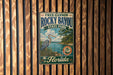 A vintage-style metal sign for Rocky Bayou State Park in Florida, featuring a blue heron and a scenic landscape.
