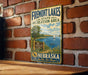 A vintage metal sign for Fremont Lakes State Recreation Area in Nebraska, featuring a scenic illustration of the lake and surrounding landscape.
