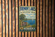 A vintage metal sign for Fremont Lakes State Recreation Area in Nebraska, featuring a scenic illustration of the lake and surrounding landscape.