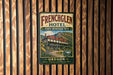 A vintage-style metal sign for the French Glen Hotel, featuring a large image of the hotel building and a scenic mountain backdrop.