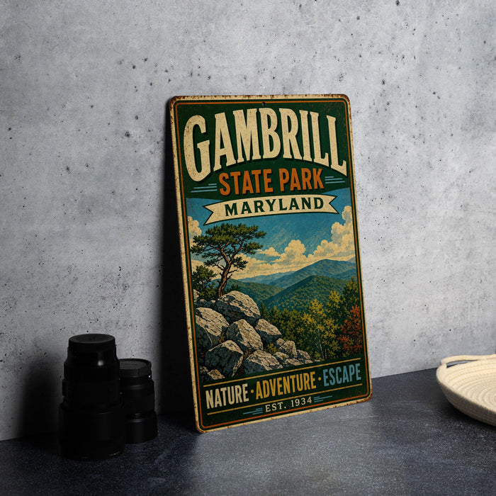 A vintage-style metal sign for Gambrill State Park, Maryland, featuring a scenic mountain landscape with a pine tree and rocks.