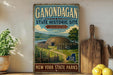 A vintage-style sign for the Gondagan State Historic Site, featuring a depiction of a Native American dwelling surrounded by a wooden fence and a scenic landscape.