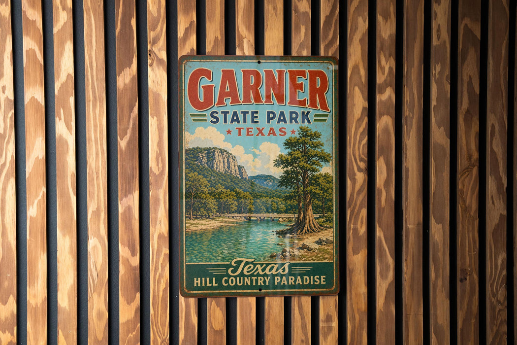 A vintage metal sign for Garnier State Park in Texas, featuring a scenic landscape with a river and mountains.
