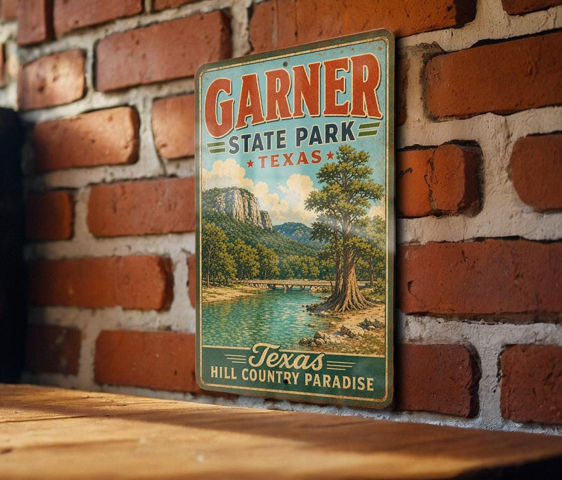 A vintage-style metal sign for Garner State Park in Texas, featuring a scenic landscape with a river, mountains, and trees.