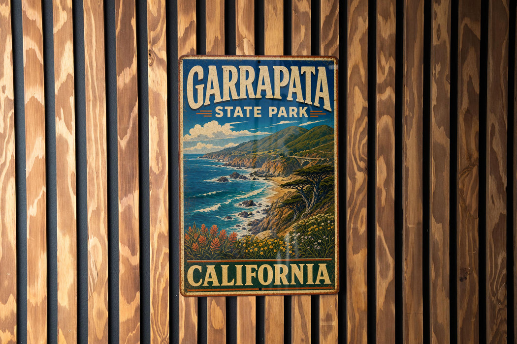 A vintage metal sign for Garrapata State Park in California, featuring a scenic coastal landscape with mountains, ocean, and flowers.