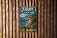 A vintage metal sign for Garrapata State Park in California, featuring a scenic coastal landscape with mountains, ocean, and flowers.