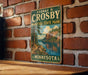 A vintage metal sign for George H. Crosby, Minnesota State Park, mounted on a brick wall.