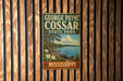 A vintage metal sign for George Payne Cossar State Park in Mississippi, featuring a scenic landscape with a lake, trees, and a boat.