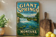 A vintage-style sign for Giant Springs State Park in Montana, featuring a scenic image of a waterfall and mountains.