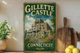 A vintage-style sign for Gillette Castle, a historic landmark in Connecticut State Park, featuring a castle-like structure surrounded by lush greenery.