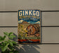 A vintage-style metal sign for Ginkgo Petrified Forest State Park in Washington, featuring a colorful illustration of a petrified tree trunk and a mountain backdrop.