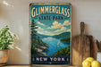 A vintage-style metal sign for Glimmerglass State Park in New York, featuring a scenic landscape with a lake, mountains, and a sailboat.