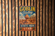 A vintage-style metal sign for Goblin Valley State Park in Utah, featuring a desert landscape with a large rock formation.