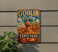 A vintage-style sign for Goblin Valley State Park in Utah, featuring a desert landscape with rock formations and a mountain range.