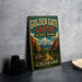 A vintage-style metal sign for Golden Gate Canyon State Park in Colorado, featuring a scenic illustration of the park's landscape.