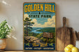 A vintage-style sign for Golden Hill State Park, featuring a scenic landscape with a river, mountains, and pine trees.