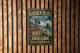 A vintage-style metal sign for the Golden State Heritage Site in Oregon, featuring a scenic image of the state's natural landscape.