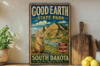 A vintage-style metal sign for Good Earth State Park in South Dakota, featuring a mountain landscape and a prairie dog.