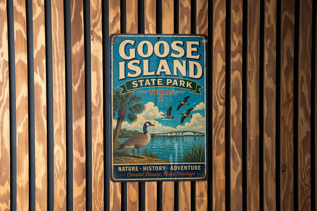 A vintage-style metal sign for Goose Island State Park in Texas, featuring a goose and palm trees, is displayed on a wooden wall.