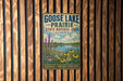 A vintage-style metal sign for Goose Lake Prairie, Illinois, featuring a scenic landscape with a lake, flowers, and a blue sky with clouds.
