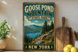 A vintage-style sign for Goose Pond Mountain State Park in New York, featuring a scenic mountain landscape with pine trees and a lake.